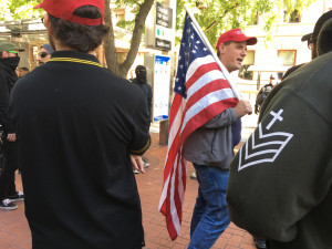 Patriot Prayer attendees, including Proud Boy in black polo with gold trim (Jasmin Moneymaker)