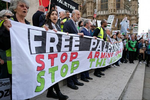 From a London protest: a line of people holding a banner that reads "Free Palestine/ Stop Arming Israel/ Stop the Killing"