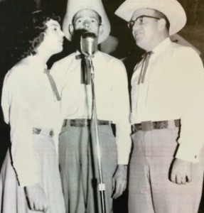 Image of Louise Rowe, Rusty McDonald and Eldon Shamblin singing around a microphone