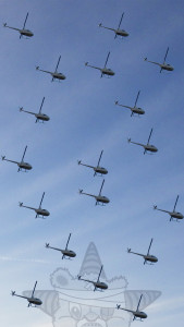 A sky full of helicopters with the Self Help Radio logo in the back.